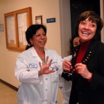 CDFA Environmental Scientist Nelida Castillo-Padron presents a colorful strand of lights to Secretary Ross