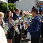 FFA members handing out flowers at Ag Day