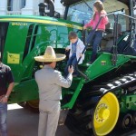 Kids climbing off a large tractor at Ag Day