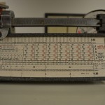 A Triner brand postal scale from the mid-1970s, showing a first class rate of 10 cents for the first ounce.