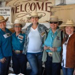 Ranchers posing in their both on Ag Day