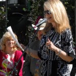 Kitty O'Neal with KFBK Newsradio speaks at a microphone