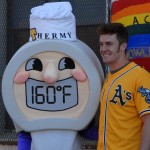 Mark Canha of the Oakland A's poses with food safety mascot Thermy