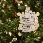 A microscope ornament hanging on a Christmas tree