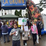 Kids carried signs reading Fruits & Veggies for a Healthy Life!