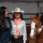 Assemblymember Sabrina Cervantes and Miss Rodeo California Amanda Hop posing with horses